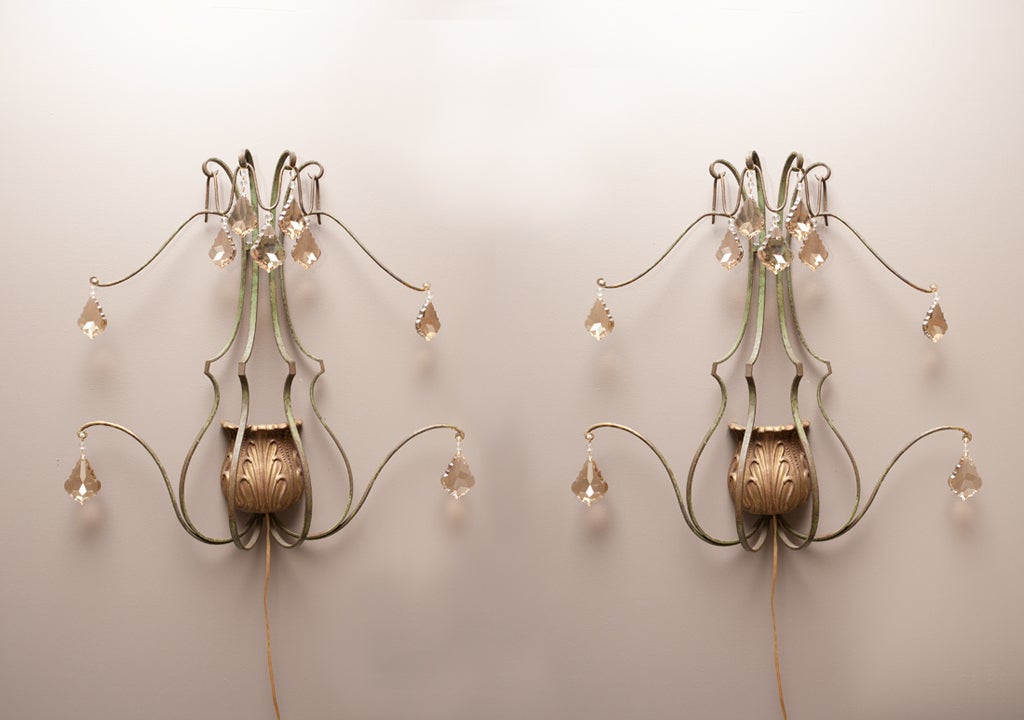 Large scale, French, pale green painted iron sconces with gilt carved light diffusers. Accented with new crystal champagne colored crystals.
Crystals measure 2