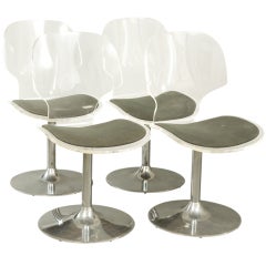 Four Lucite Swivel Chairs