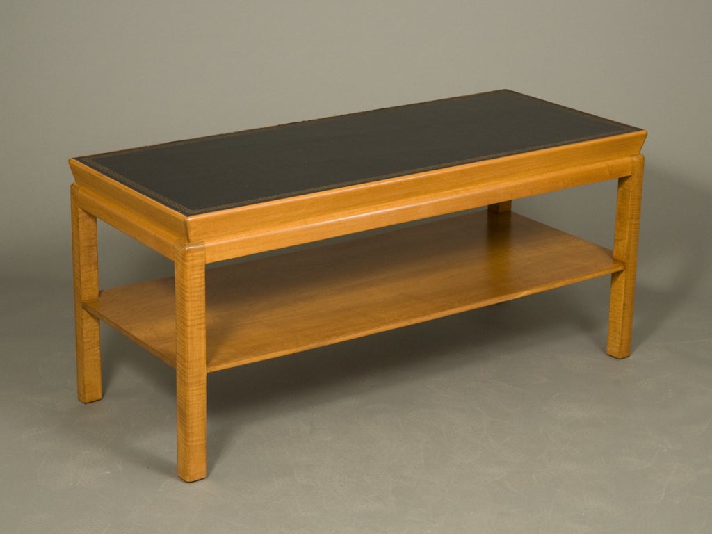 Mid-Century modern oak coffee table with black leather top with gilt embossed border and lower shelf.