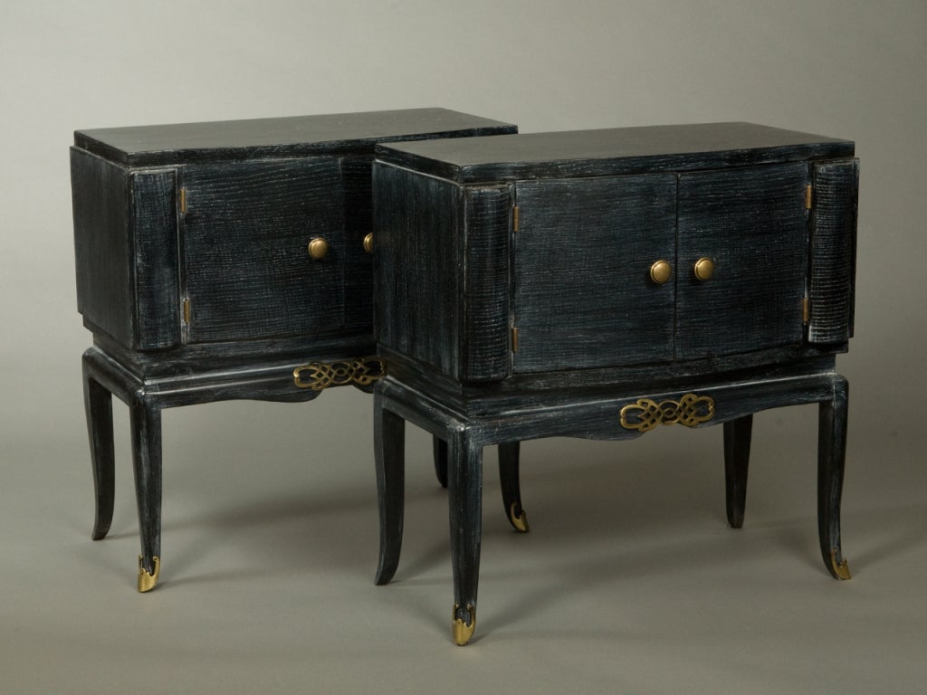 Pair of French Deco black cerused nightstands with two doors and decorative antique brass finish hardware.