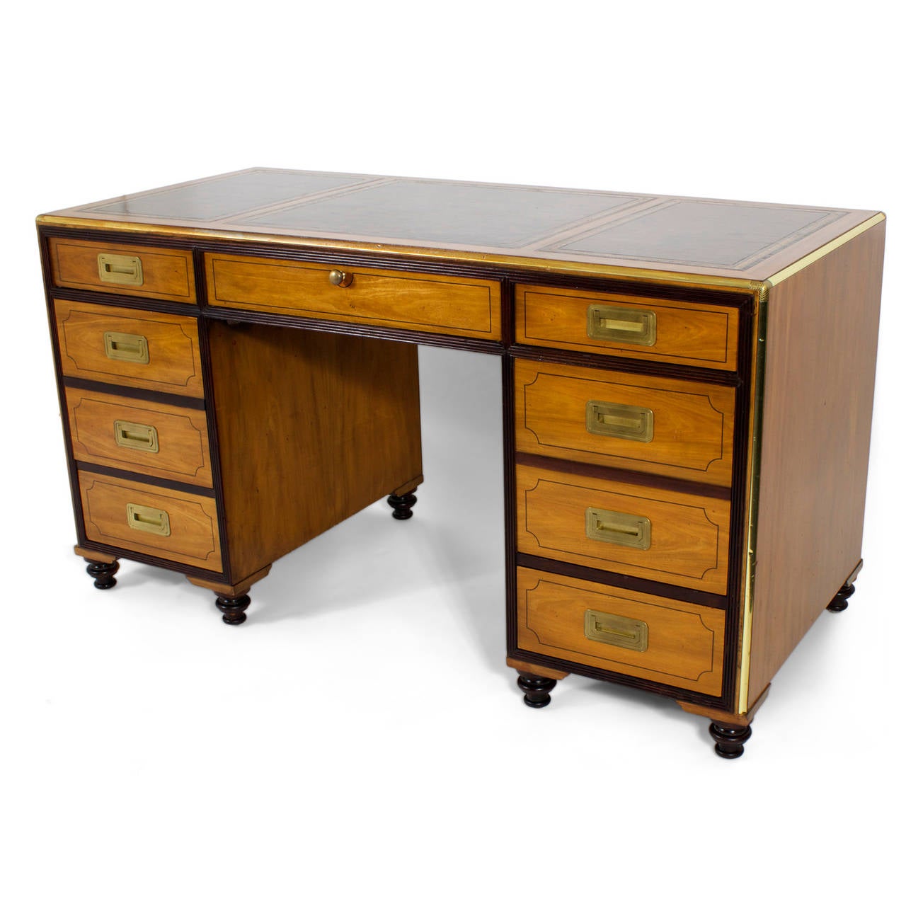 A brass labeled Baker collectors edition Campaign style desk in two-tone mahogany, with turned feet, brass trim and recessed hardware, three panel tooled leather top, reeded banding surrounds the drawer fronts. The other side of the desk, designed