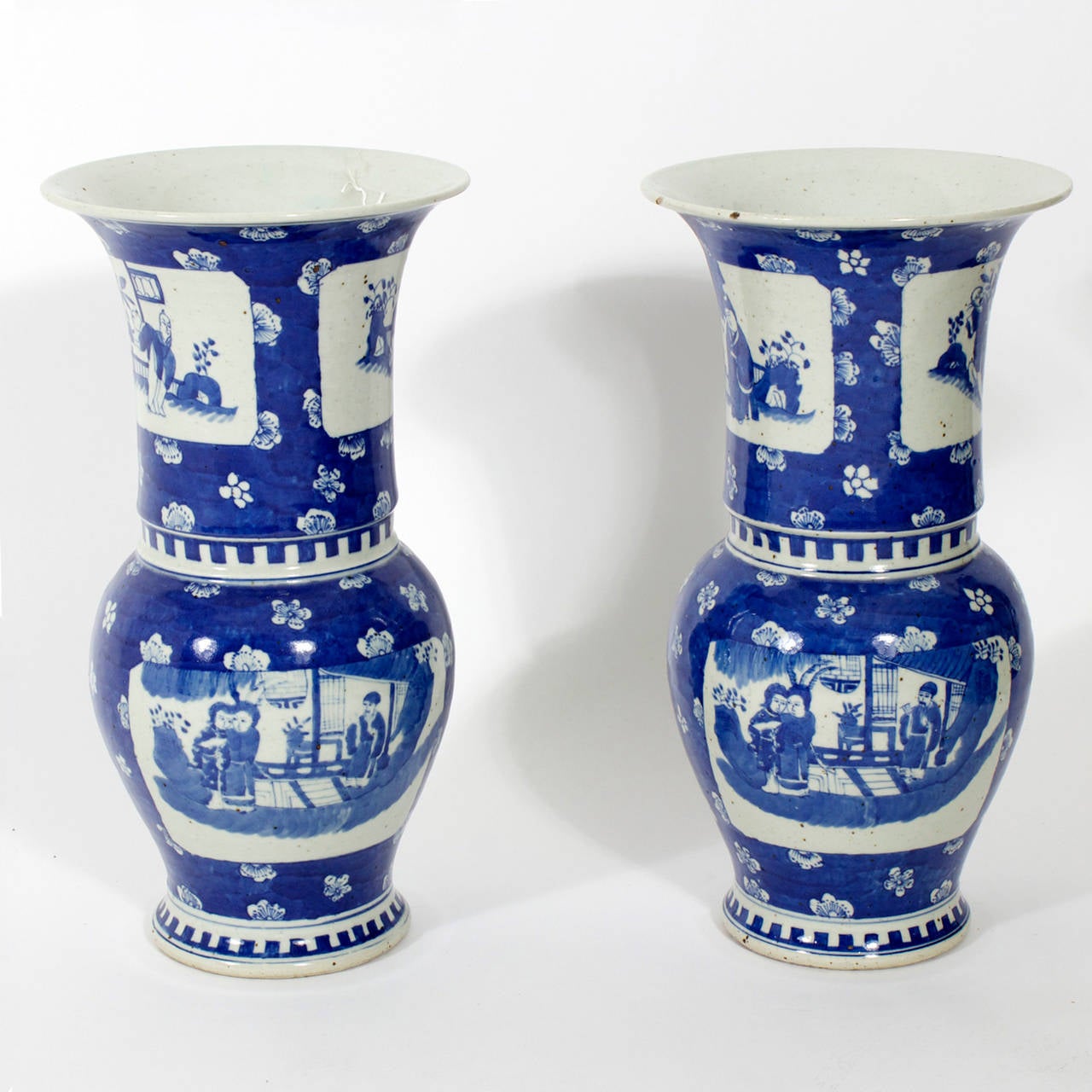 A pair of Chinese export blue and white vases with scene motif cartouches, on a cherry blossom or prunus background. Nice form.