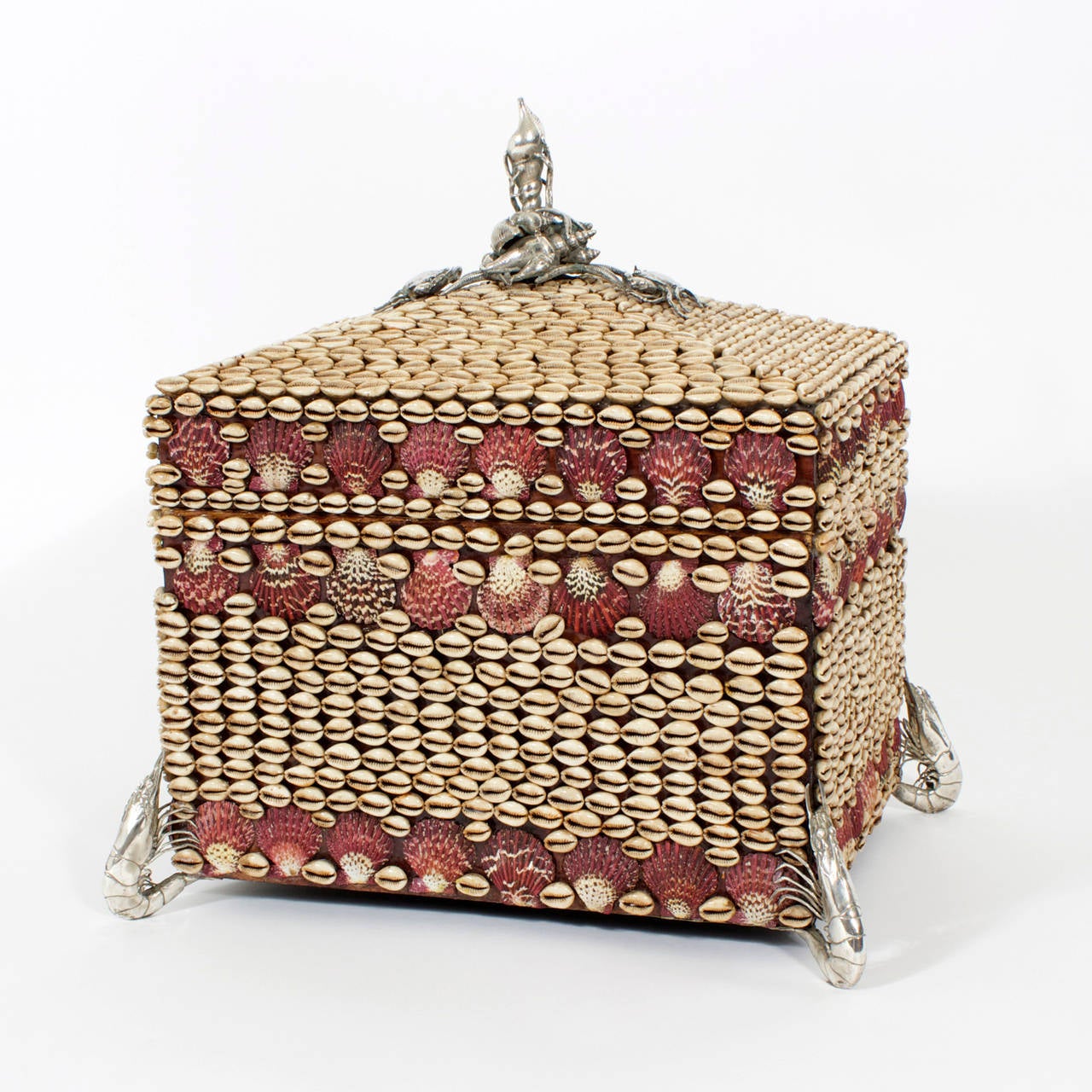 A large cowrie and pectin seashell encrusted box with removable lid, bamboo lining and silvered metal lobster feet and crab and shell finial. Large, dynamic and very appealing. Probably Maitland Smith.

 