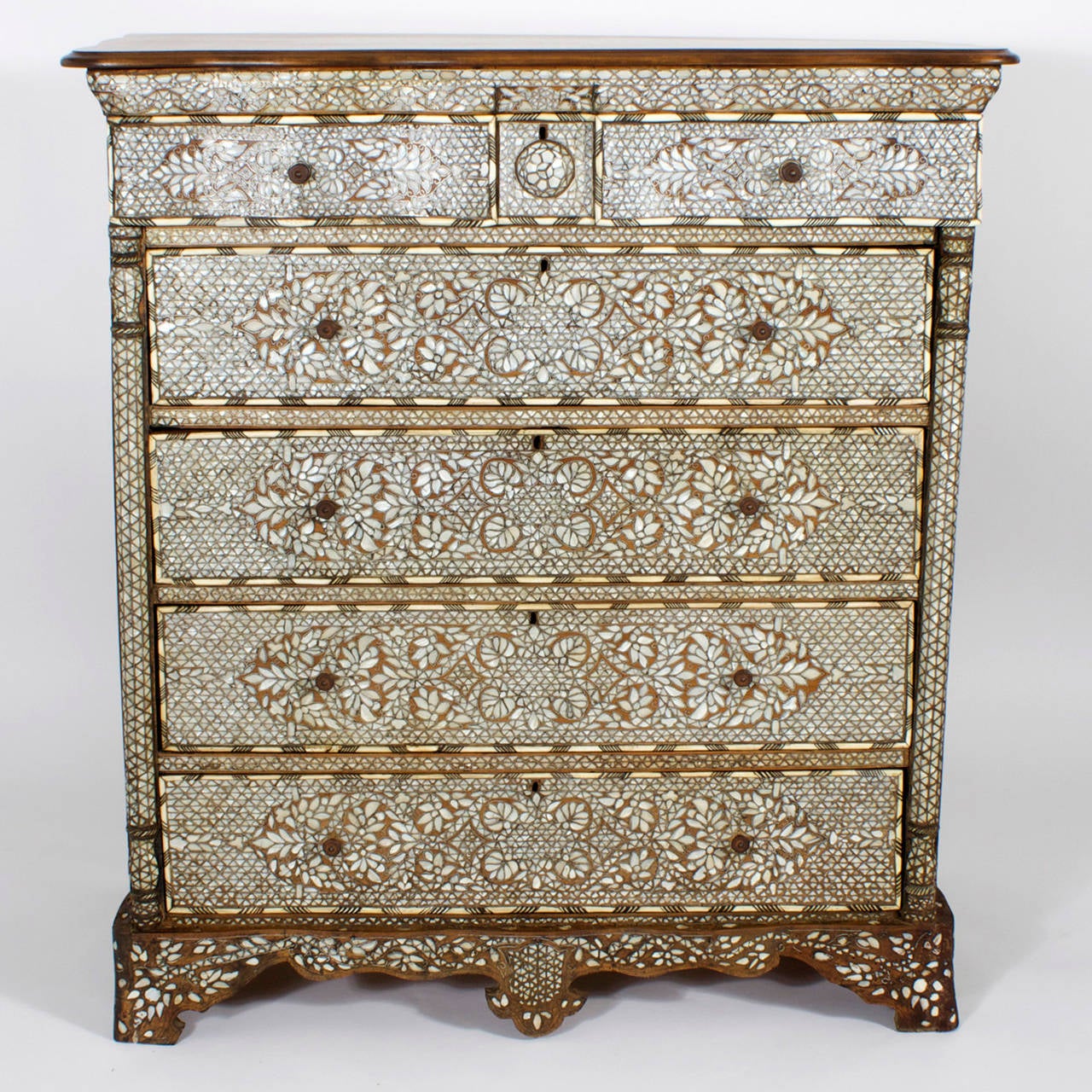 A fine and important antique Syrian gentleman's chest of drawers, made in hardwood and intensely decorated with bone and mother-of-pearl inlaid geometric and floral designs. This incredible seven drawer chest, boasts turned split quarter columns,