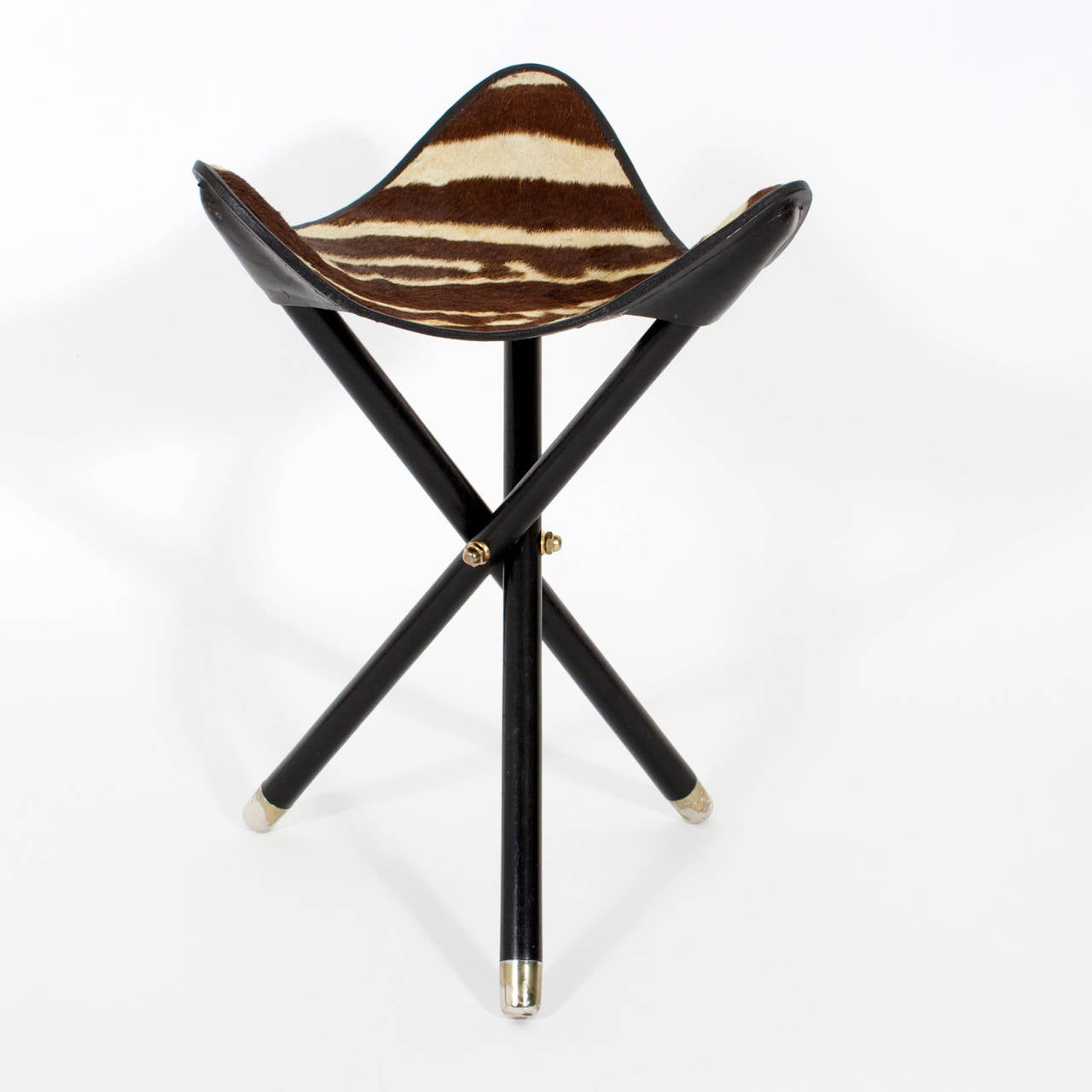 Burchell zebra skin campaign seat or stool with a folding ebonized wood base, and contrasting brass and metal details. Perfect for your next safari.
Newly polished.