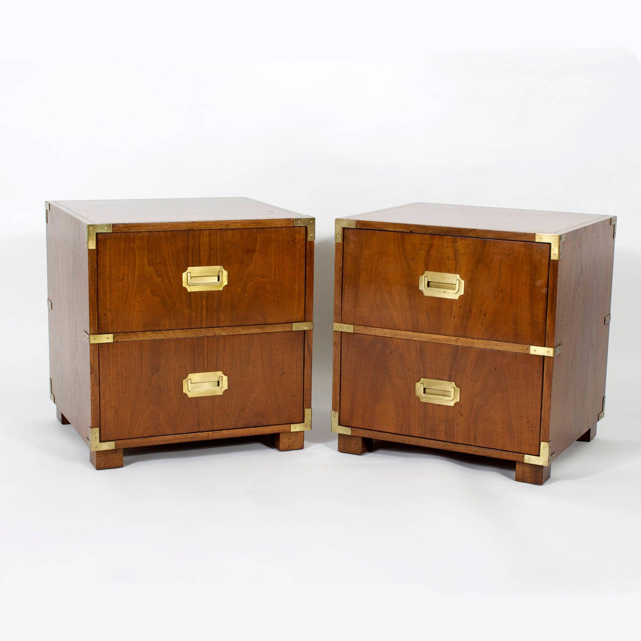 Handsome pair of mahogany Baker campaign style night stands with brass hardware, drop down drawer for extra table space and block feet. Labeled.
Newly polished.

