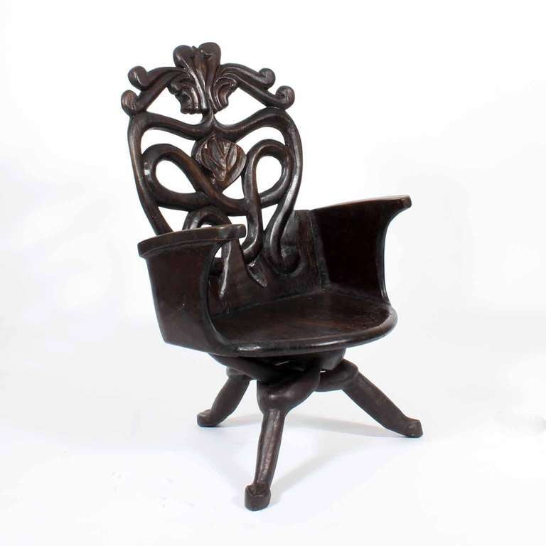 An early to mid-20th century carved hardwood chair, with intricately carved base, reminiscent of carved wood stands from India and Africa. Very decorative chair.
Seat measures: 16.5 x 14 H. 

 