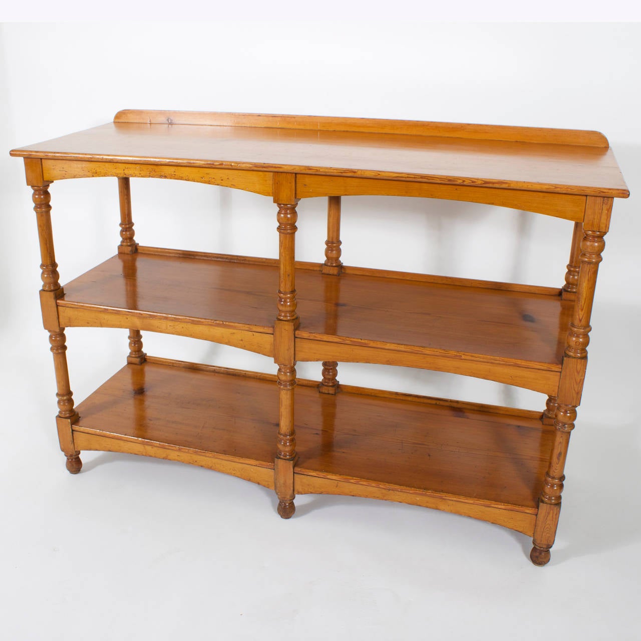 A late 19th C. 3 tiered English pine server, set of shelves or etagere with turned supports and feet, scalloped skirts and a warm aged finish. Classic lines, with plenty of room for display. Newly polished.
 