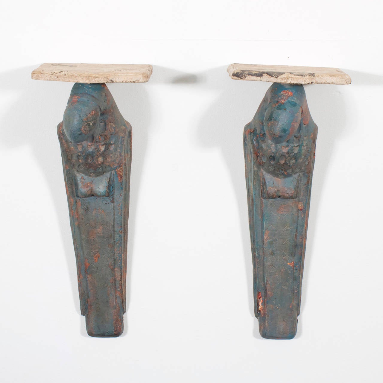 A whimsical pair of vintage composite parrot brackets in a preening posture with old distressed paint and natural terra cotta color shaped shelves.