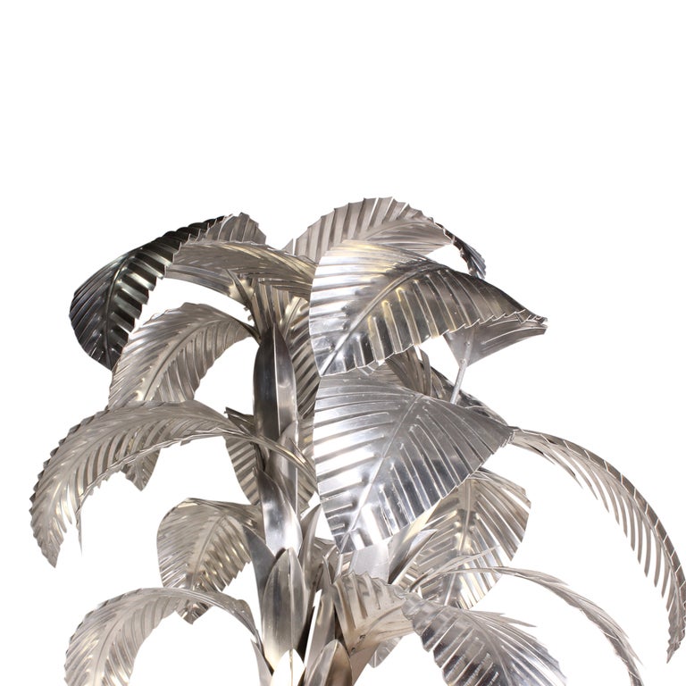 A large aluminum palm tree with removable leaves, signed H. Links 1973, in a large weighted aluminum covered pot. Beautiful movement to the fronds and trunk.

Palm trees - fshenemaderantiques.com