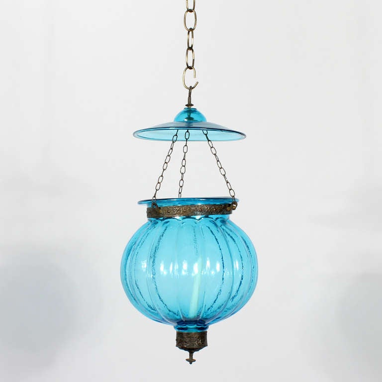 Set of 3 late 19th or early 20th C.Anglo Indian, blue colored glass bell jar lanterns or pendant lights, with the original candle sockets and etched bronze fittings. These fixtures can be electrified if necessary. They evoke the romantic, with
