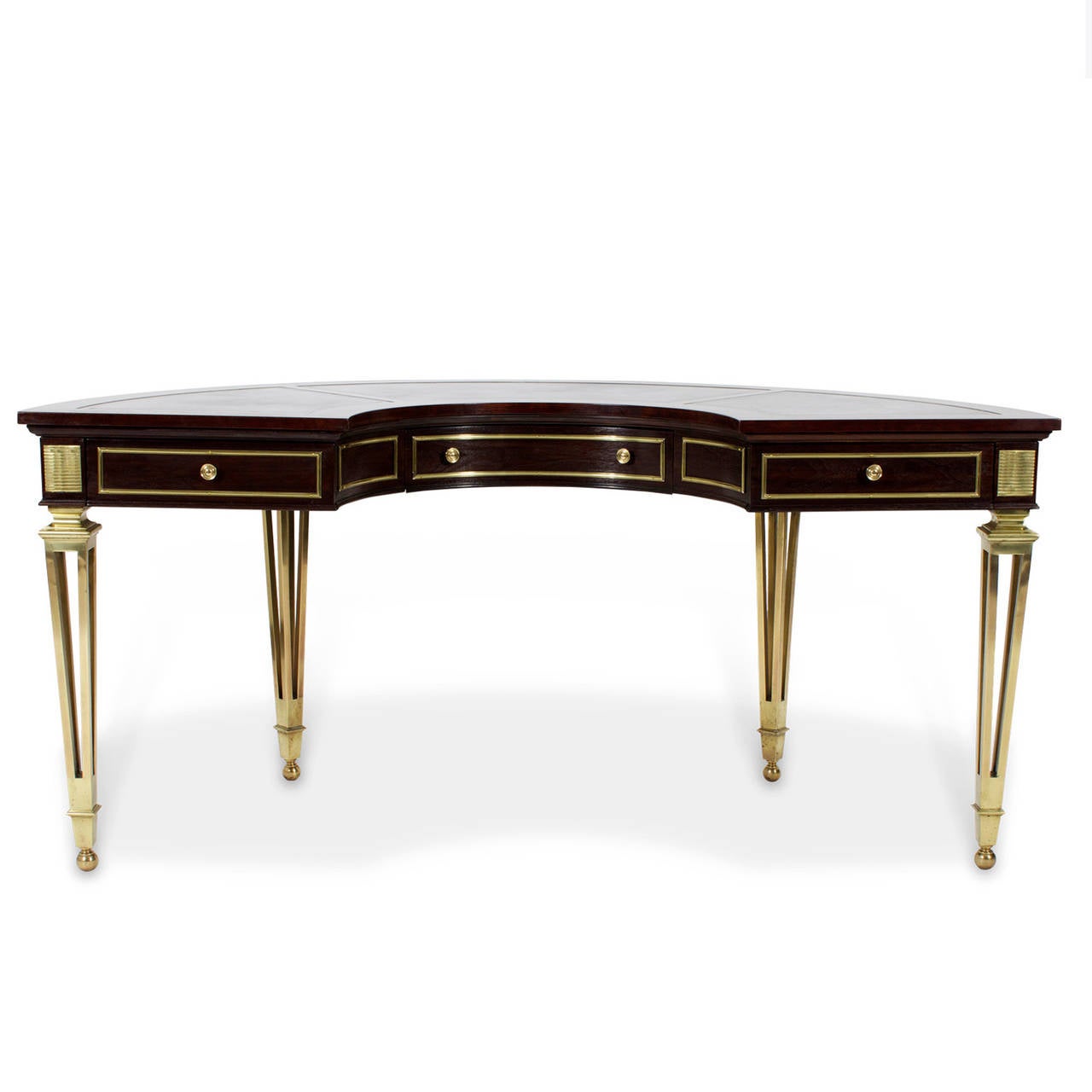 A labelled mastercraft burl wood demilune desk featuring a brass trimmed concave centre drawer flanked by brass trimmed panels and two drawers. Four bronze tapered legs with ball feet, topped with reeded brass panels. The reverse with three brass