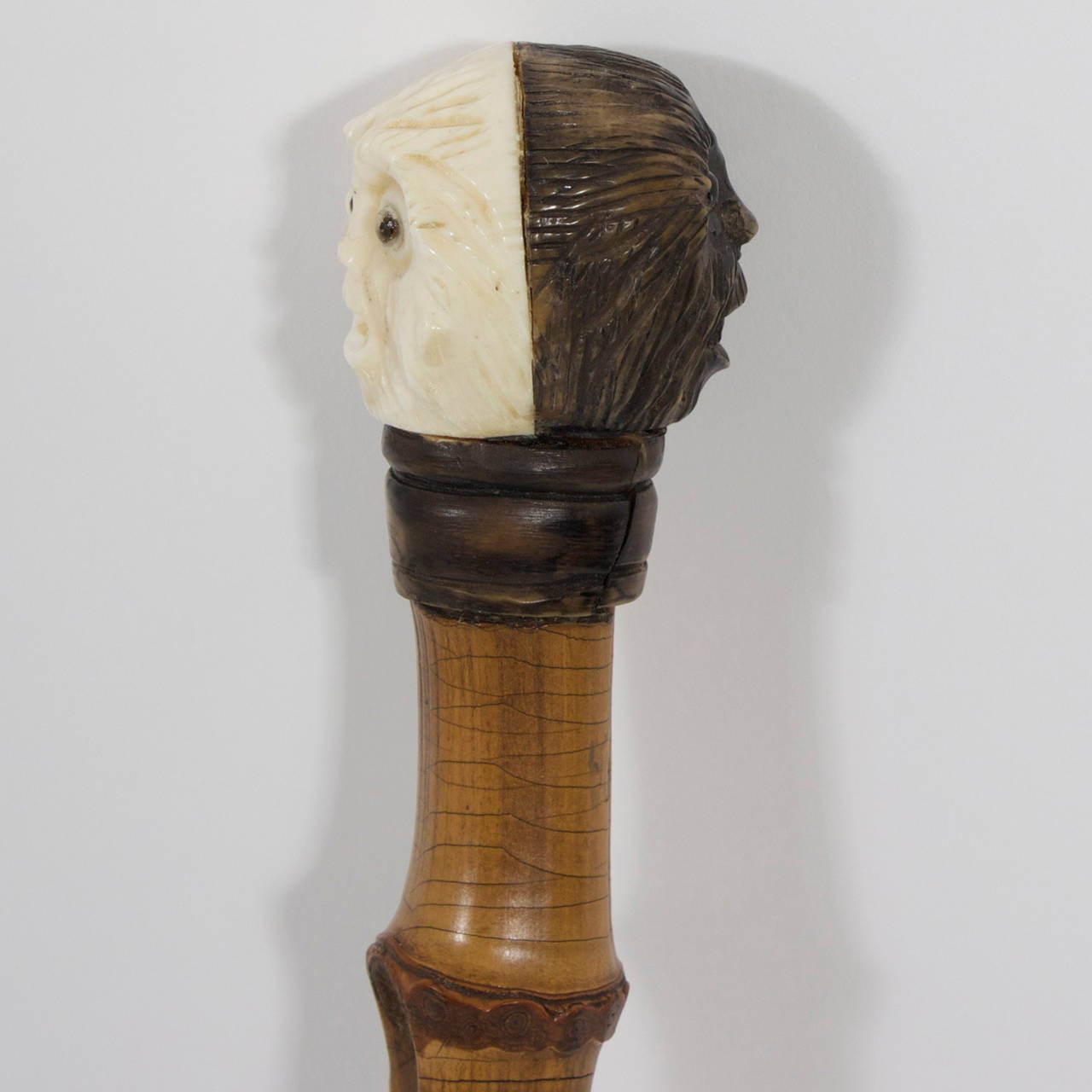 Humorous, vintage walking stick or cane with a two faced black or white surprised monkey as a handle and a bamboo shaft that is full of personality. A great example of the art of cane making.