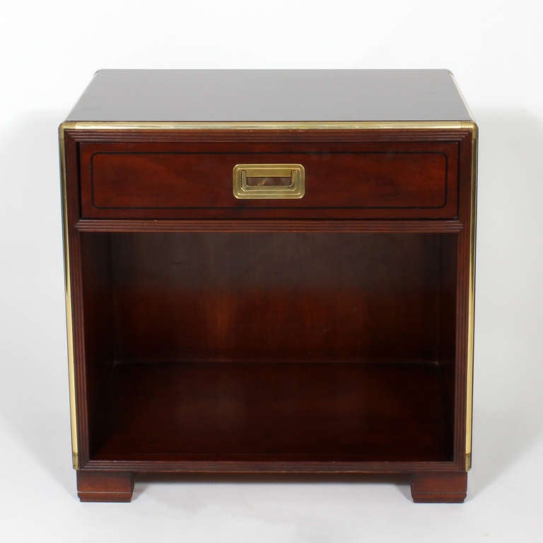 A pair of high quality Baker nightstands, or tables, campaign in style, mahogany with etched brass trim, line inlay, and block feet.  Newly polished.