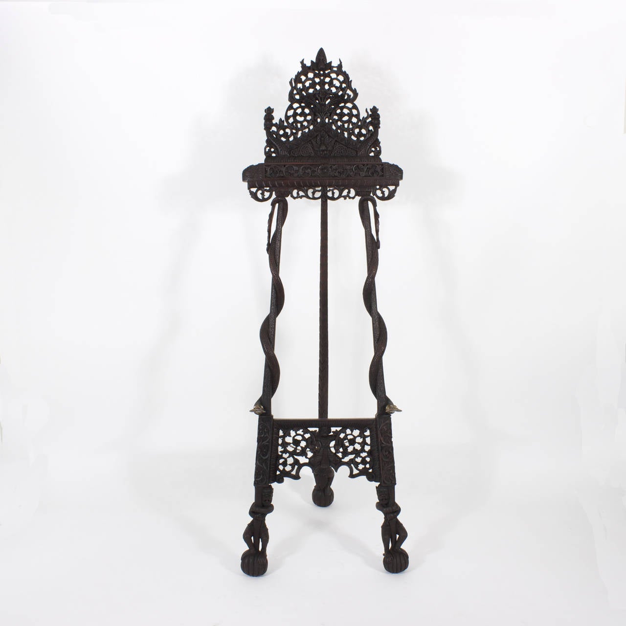 Rare and expertly carved, Anglo Indian wooden tripod easel. Representing a fantasy of mythological characters and animals including brass cobra head painting rests. A piece of art made to hold a piece of art.