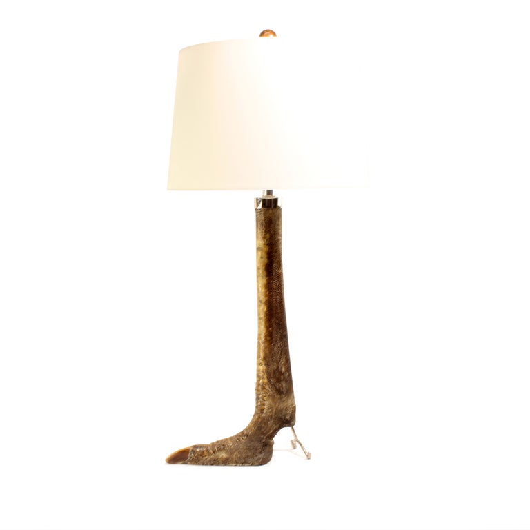 A pair of taxidermy ostrich leg lamps with silver metal collars and stands. Bold, with great markings.

Interesting lamps...fshenemaderantiques.com
