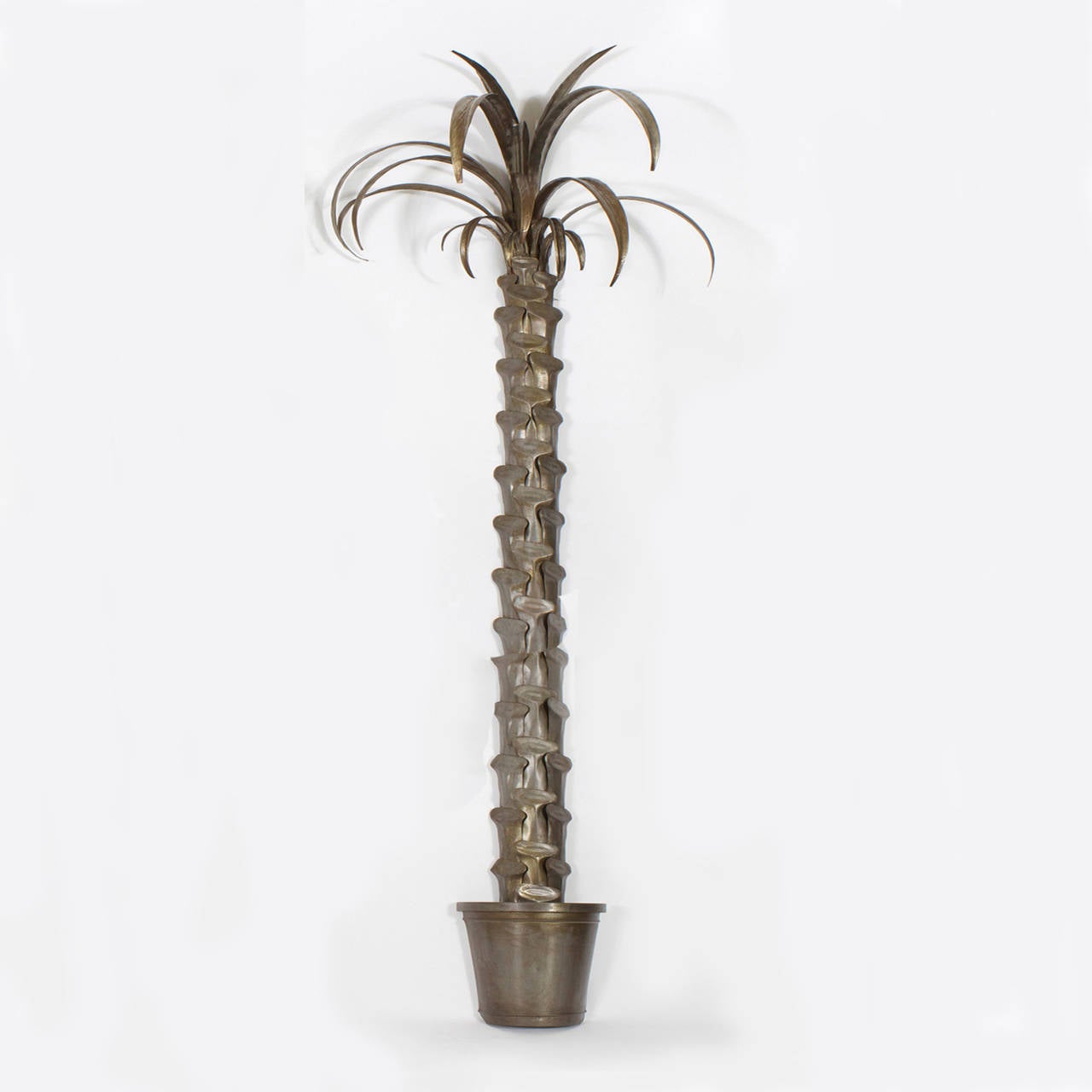 Pair of patinated metal, wall mounted potted palm trees with a chic, mid century feel. Tall, stately scale and packed with drama. This is as good as it gets. Classic and modern all rolled into one. Depth of pot: 6