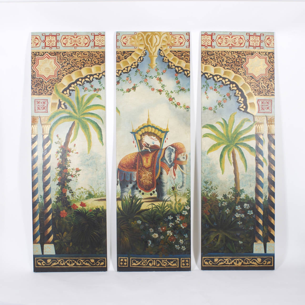 Exotic and colorful three hand-painted wood panels with a distinctive Indian flavor. An elaborately dressed elephant carrying a mysterious traveler in a fancy covered saddle, all set among palm trees and flowers with arch and columns in the