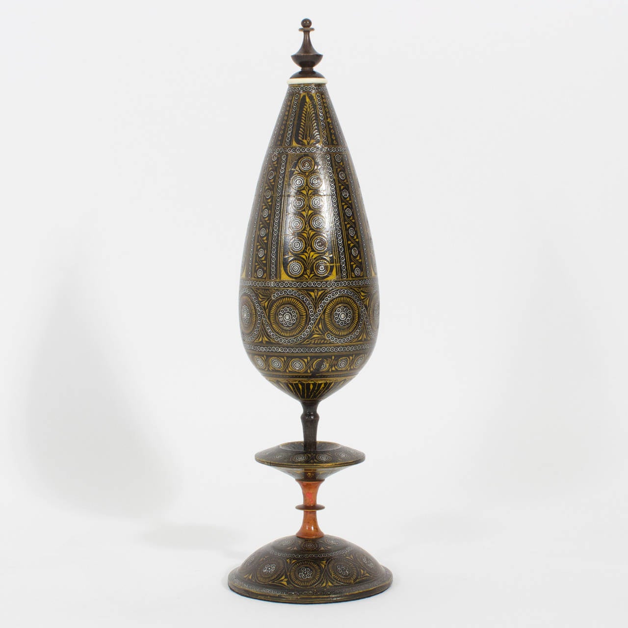 A fine and fascinating pair of carved wood and lacquered garnitures,  decorated in black, gold and ocher in a repeat floral pattern, on elegant stemmed bases with just a hint of red, on the exceptional turning, the whole topped with neoclassical