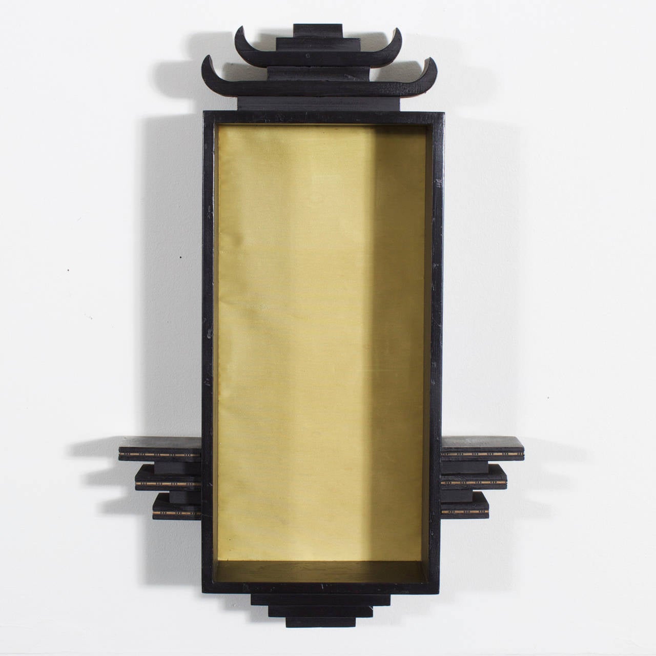 A pair of Mid-Century James Mont style Asian Modern ebonized wood wall brackets with pagoda tops and yellow silk back panels for a hint of color. A modern take on a chinoiserie style. Perfect for displaying your treasured objects in a dramatic way.