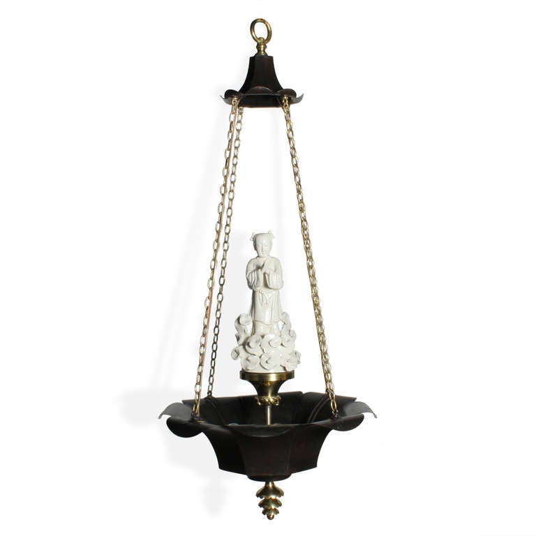 An excellent quality Chinoiserie style bronze and brass chandelier, with a central white porcelain Asian figure, brass finial, chain and figure support. Newly wired. Very elegant.

fshenemaderantiques.com for more