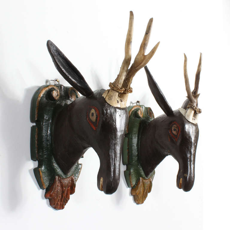 Carved and painted wood stag heads, with decorative contrasting carved backplates, and real mounted antlers. A traditional German way of mounting antlers, these pair are particularly folky. Great colors and nice to find a pair.