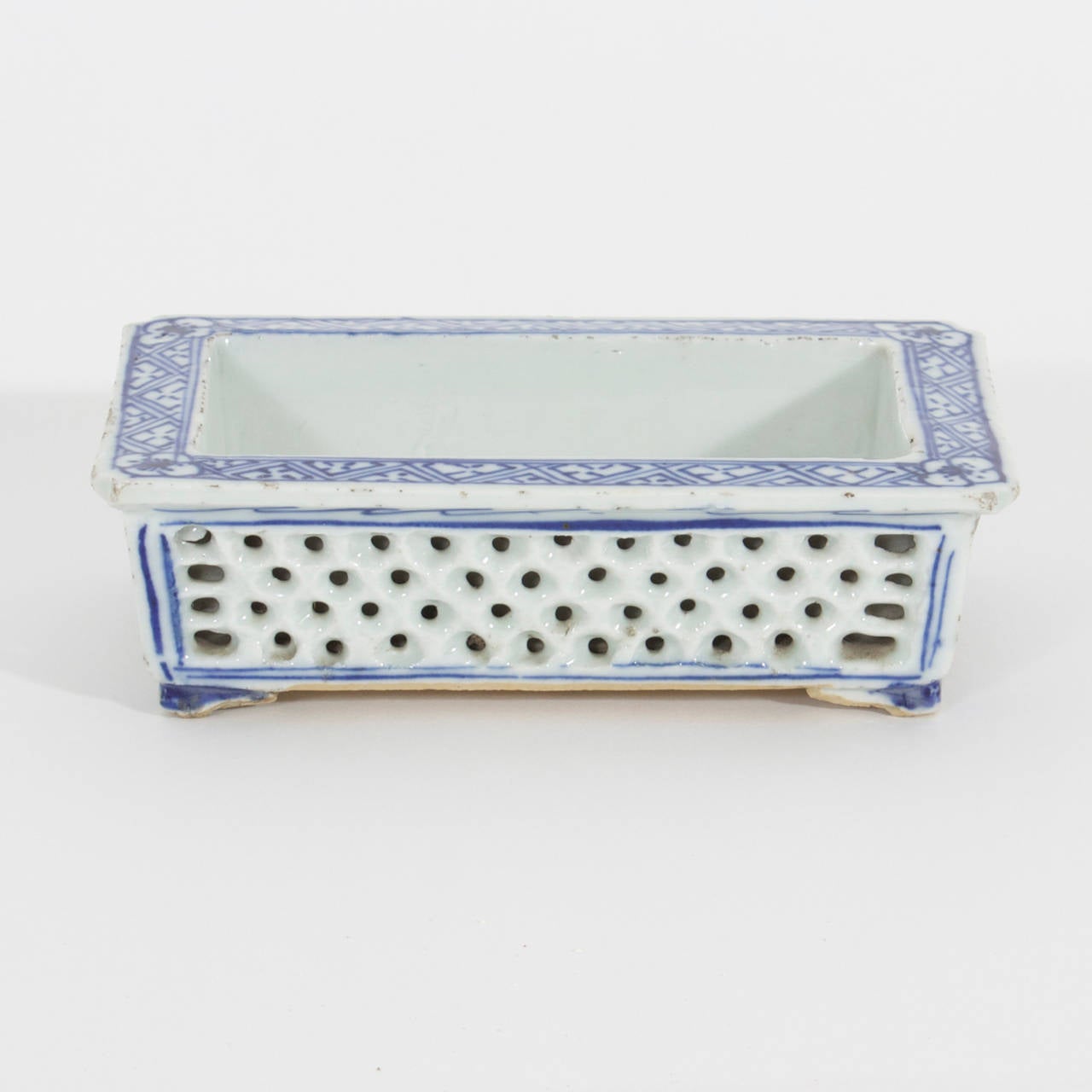 A sweet gem of a 19th C. or older Chinese Export blue and white porcelain  narcissus tray, raised on small feet. Rustic, with floral decoration, and reticulated sides. Nice size and well used.

