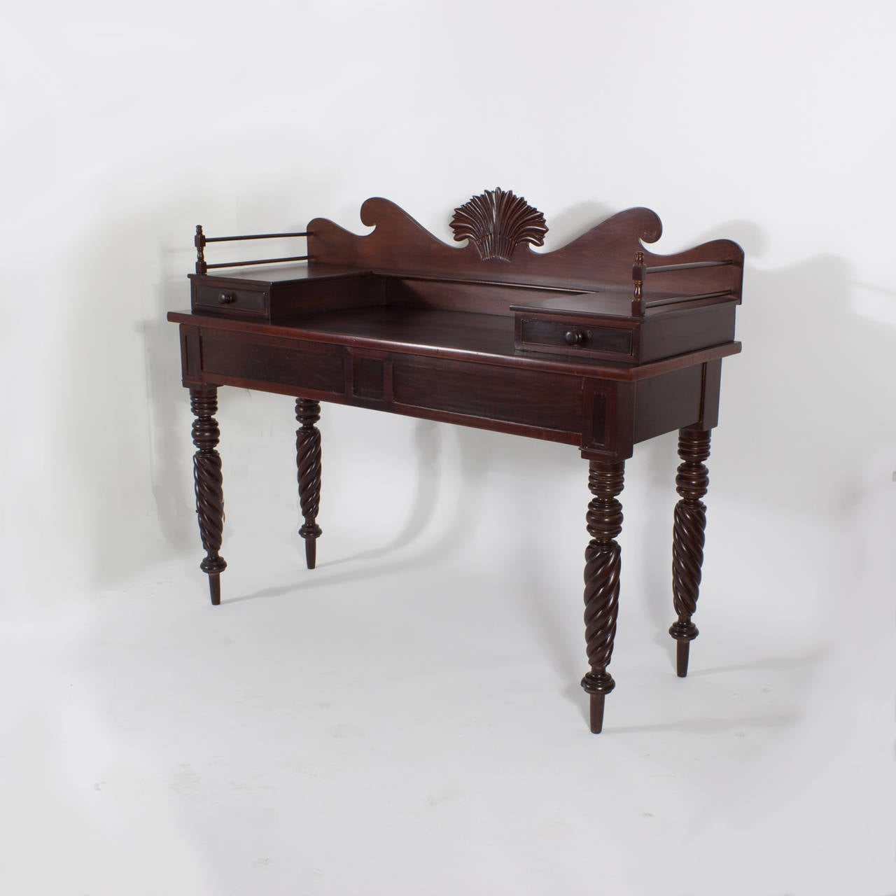 Antique Jamaican, mahogany server or with an especially dramatic form. Featuring  2 flatware drawers,the only storage on the server, a robust backboard with central symbolic wheat carving, and tall turned rope twist carved legs, all combine to make