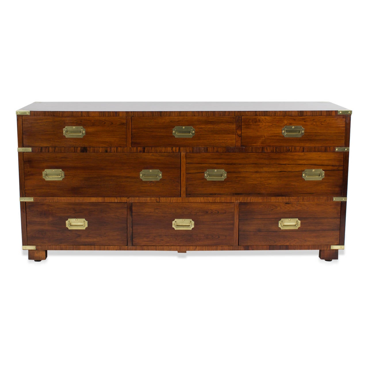 Here is John Stuart's idea of a classic campaign form brought to mid century sensibility. This campaign dresser or sideboard, is old meets new in a graceful way. Solid brass recessed campaign hardware. Beautiful rosewood graining. Newly polished. 