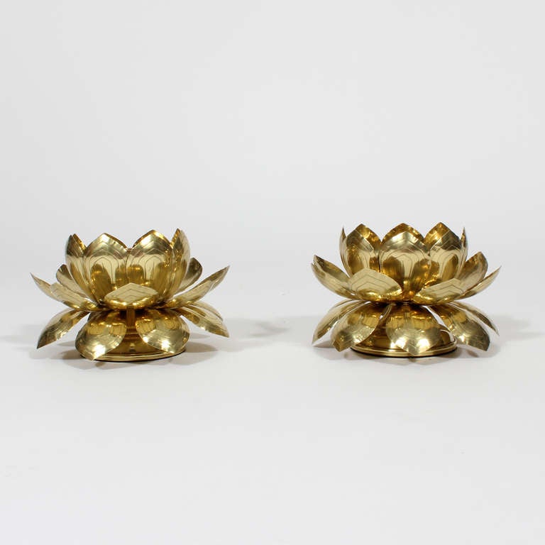 A pair of brass candle holders, in lotus form, raised on round plinth bases, with pointed and etched leaves. Newly polished. Probably by Feldman and definitely related to the lotus pendant lights that we have in another listing. Charming and