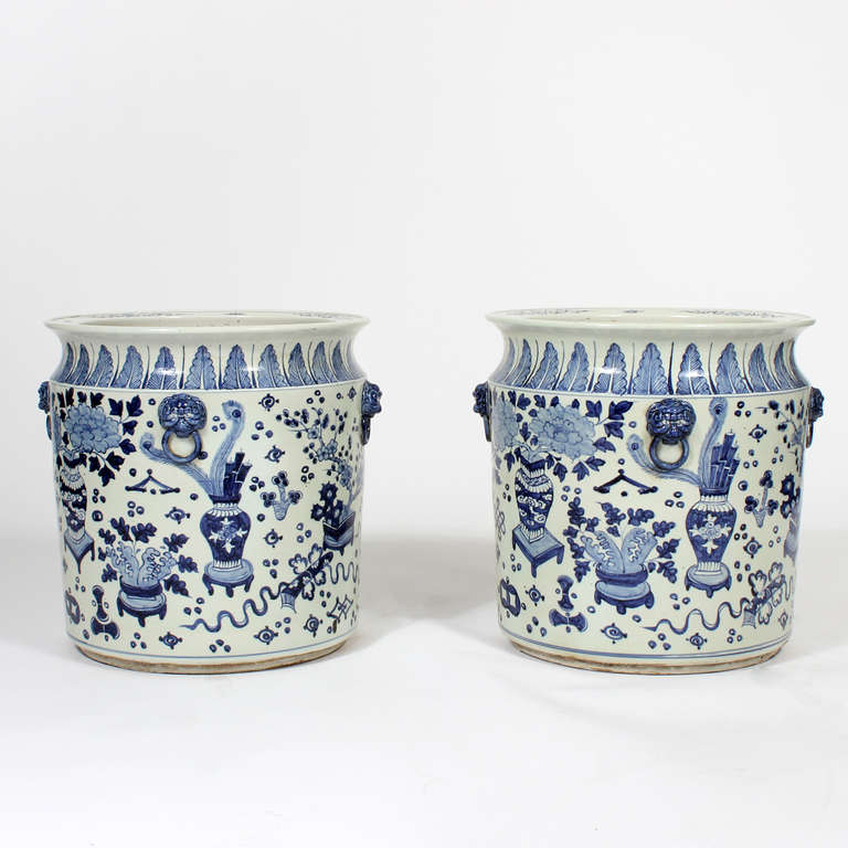 Classic Asian motifs with applied lions heads with rings, dance around these large Chinese Export blue and white planters or jardinieres. Picture these with potted palm trees, an incredible mood setter.