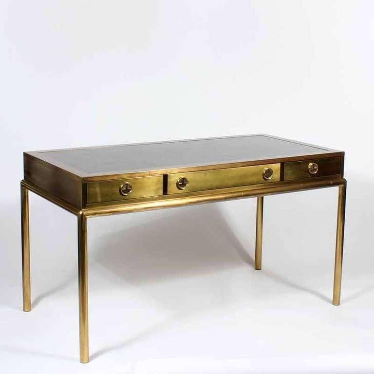 Mastercraft 3 drawer brass desk, elegant, modern sensibility with a warm friendly patina. chic and practical. Patinated brass, with a lightly tooled leather top, Asian style pulls, and round brass legs. Labeled Mastercraft.