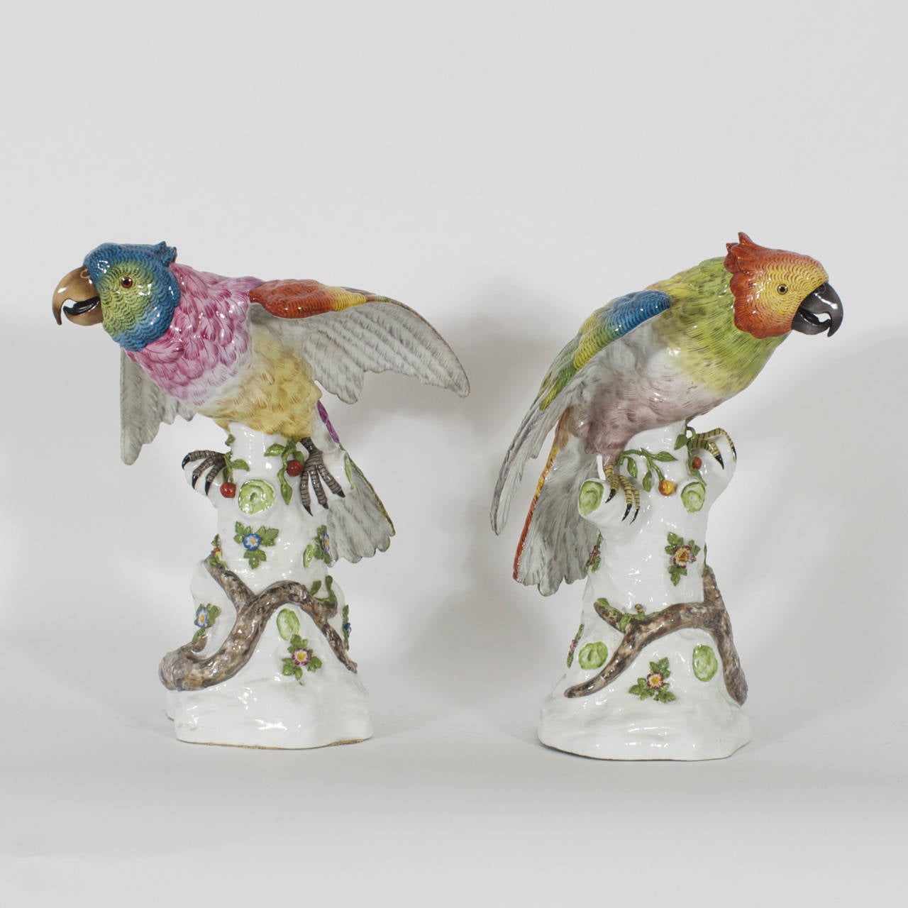 A fine pair of 19th century porcelain birds or parrots executed in old world quality, bright, colorful and loaded with charm. Signed with crossed arrows on the back of the base. Probably not Meissen or Dresden, but certainly a quality maker, based