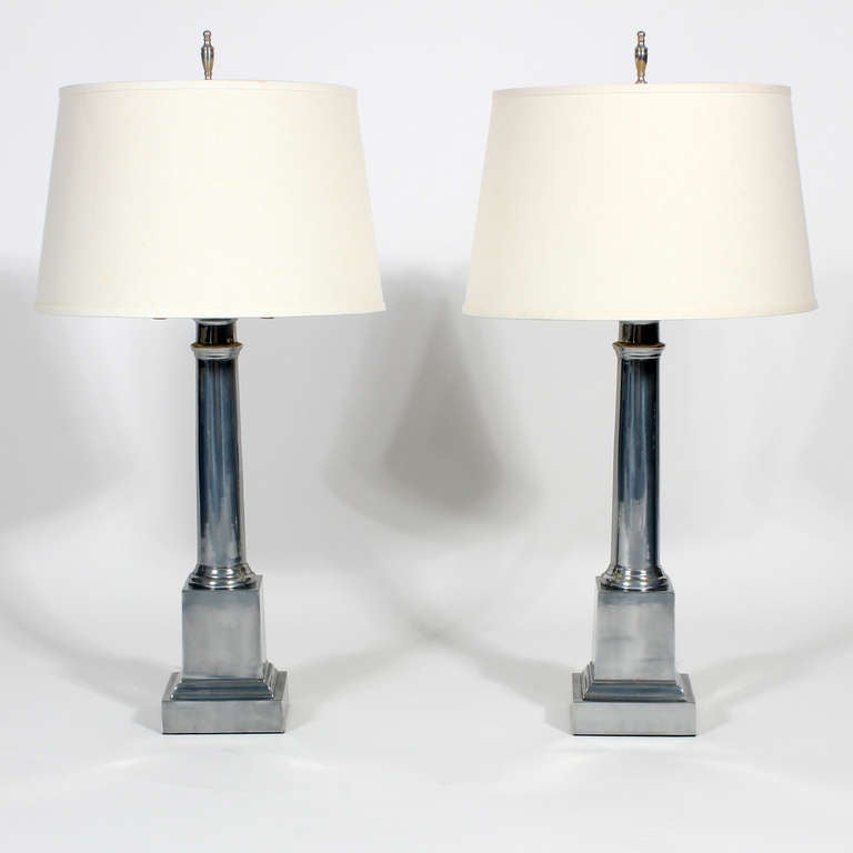 A pair of Warren Kessler aluminum lamps. Classic form with a modern reflective twist. Newly wired and with new shades.