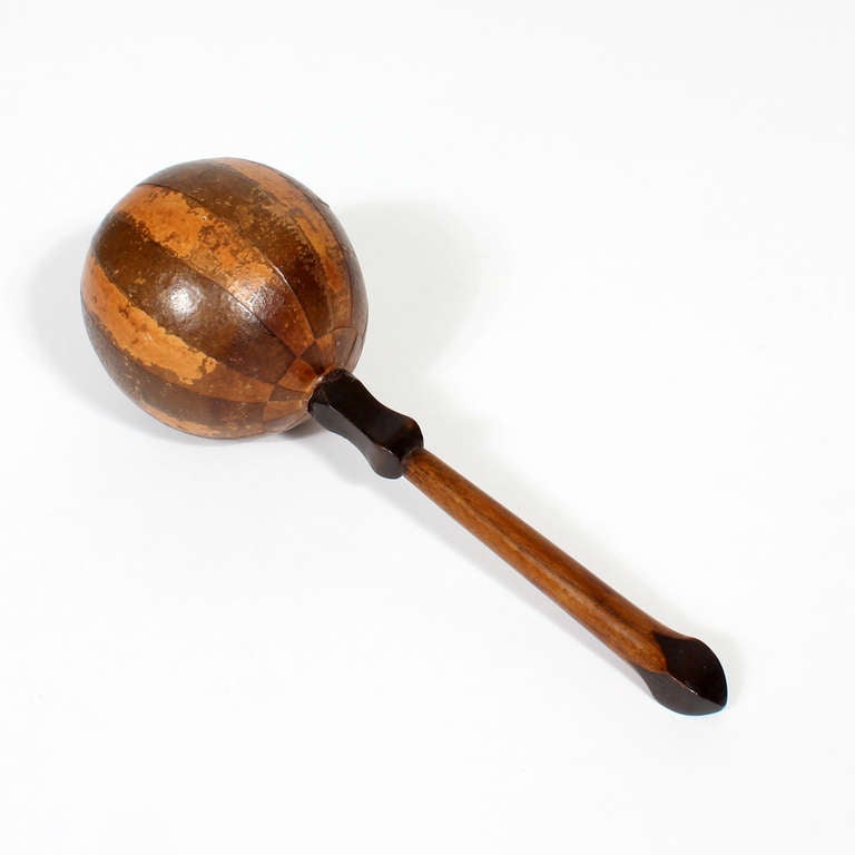 Nothing says the West Indies like  palms swaying, maracas playing, and trade winds blowing. This pair of inlaid and carved possibly coconut maracas capture it all, beautiful alternating inlaid bands on the heads, with carved contrasting stained