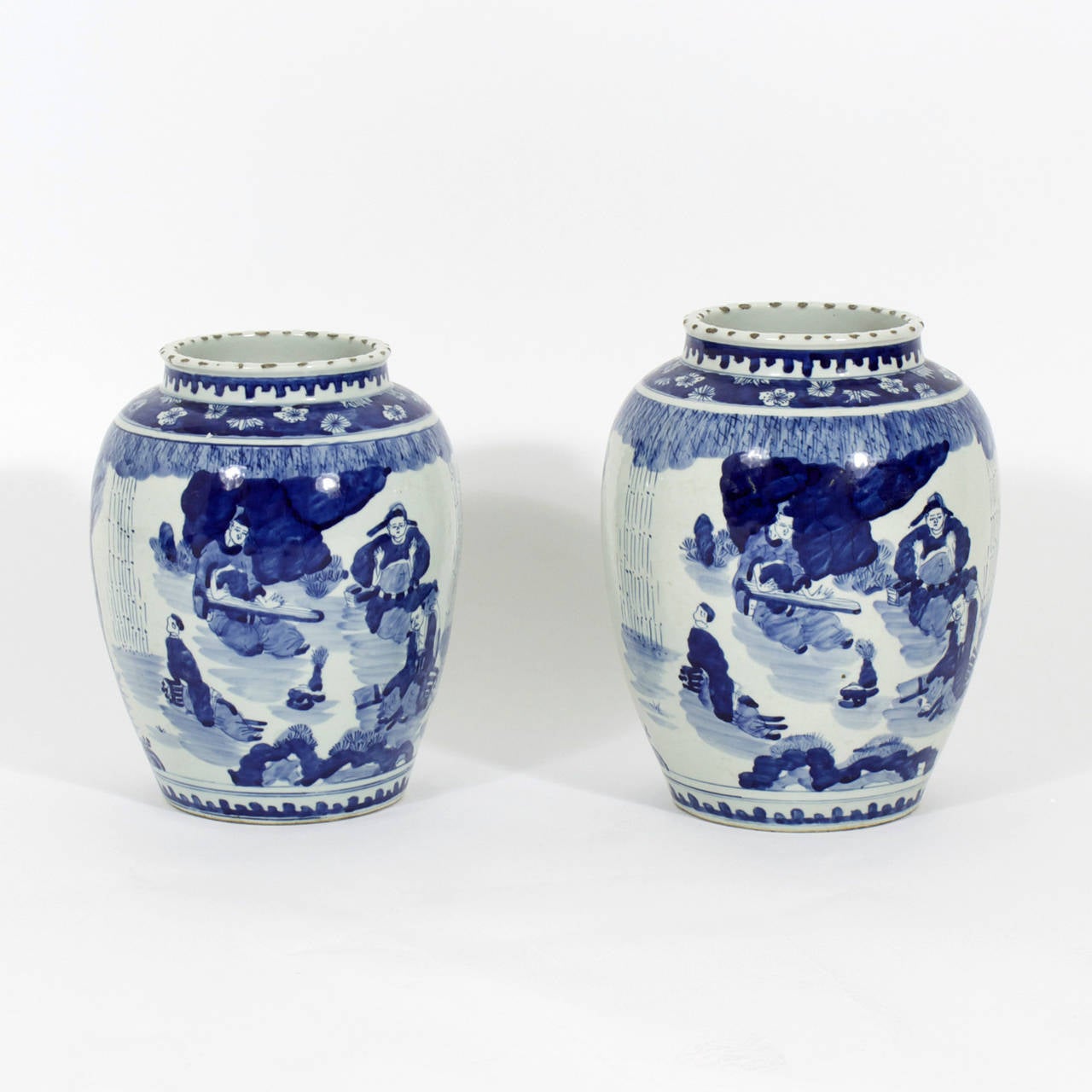 A pair of Chinese Export blue and white vases,  with tropical and and people scenes. Robust shape with nice borders. Please note that one pot is larger than the other.