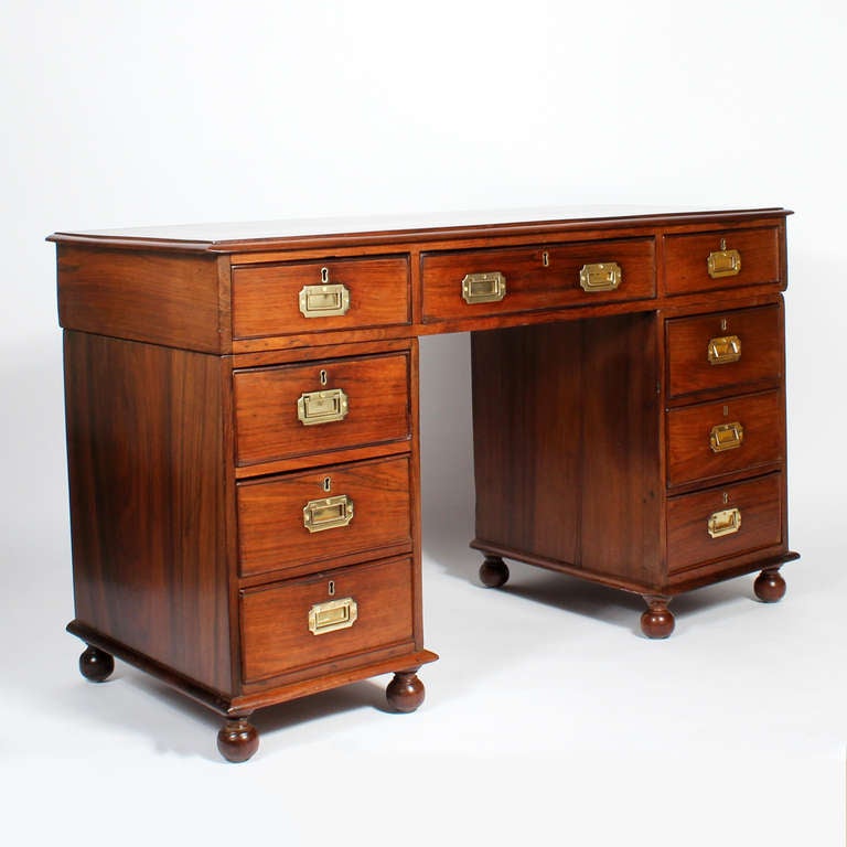 A well proportioned tropical hardwood three-part Campaign desk, with brass Campaign hardware, molded top and turned feet. A nice compact desk, with great eye appeal.
Possibly made in Asia for the English market.

 