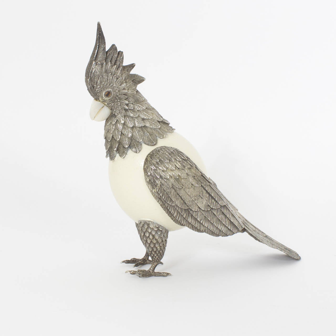 Whimsical mixed materials parrot or bird with an ostrich egg body and silvered metal feathers and feet, carved stone beak and over all sporting an air of confidence. In the manner of Binazzi.
A delightful addition to both modern or traditional