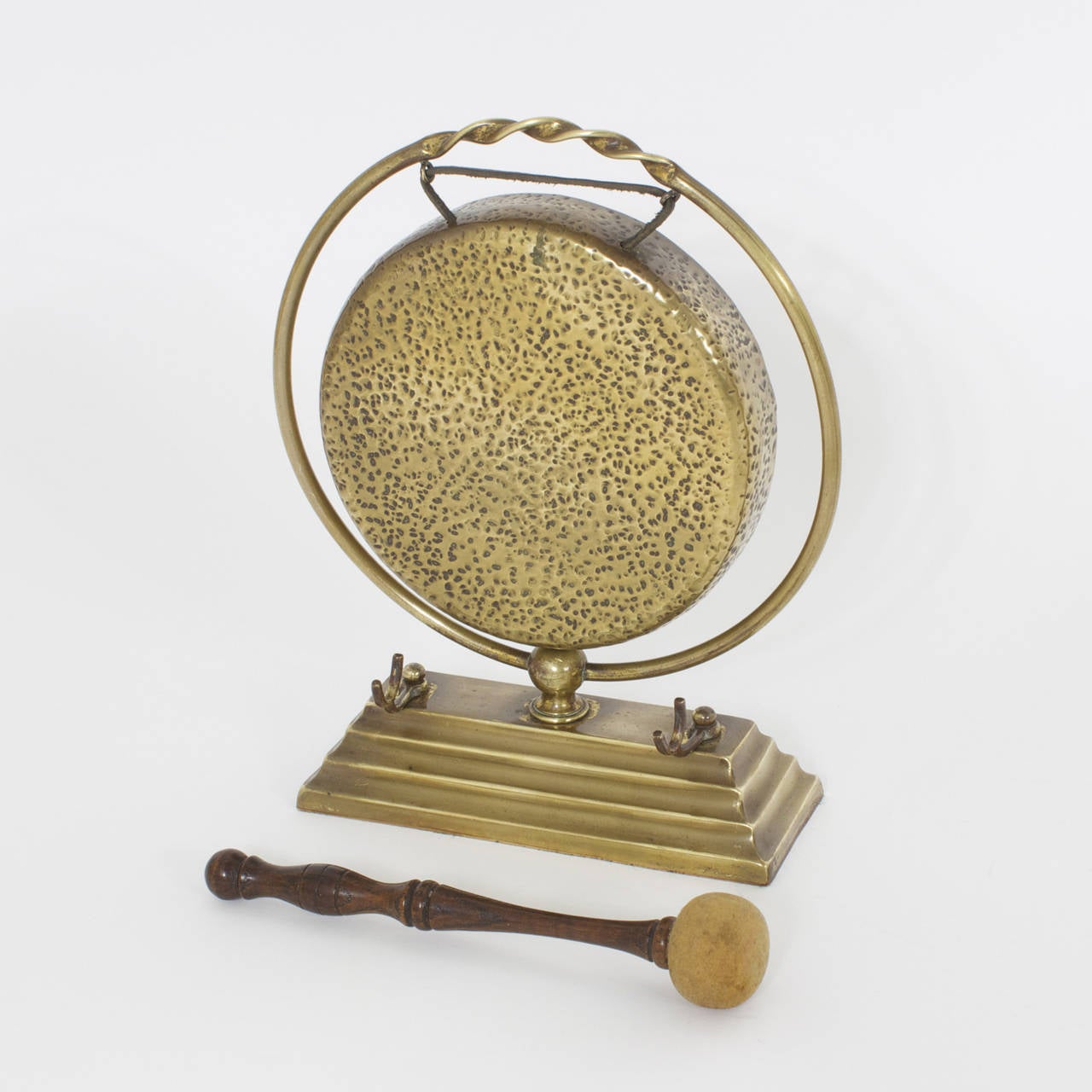 Diminutive, hand hammered brass dinner gong with a classic 4 tiered base and a hardwood turned mallet, that when rung has a beautiful resonant sound. Nicely polished.