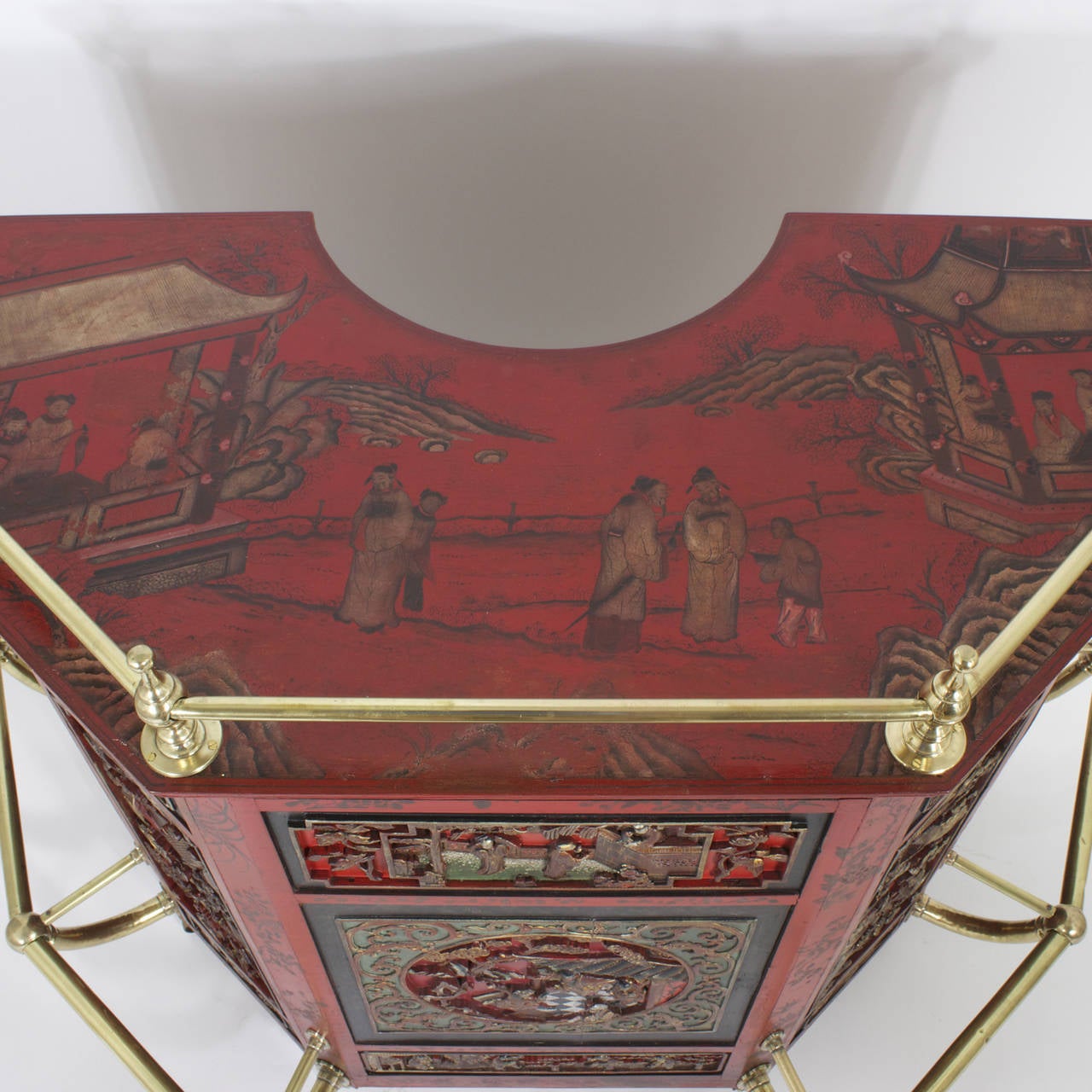 Over the top early to mid 20th C. carved wood and lacquer Chinese stand up or dry bar, in cinnabar red, with a Chinoiserie painted top and paneled with well carved scenes of the forbidden city, highlighted in gilt, and featuring some very serious