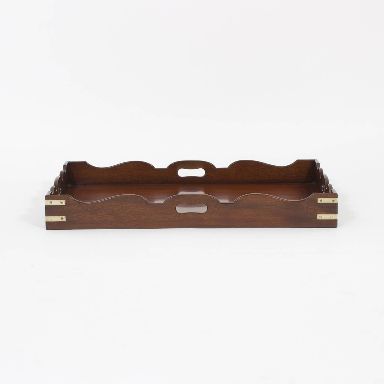 High quality mahogany campaign serving tray with scalloped edges and four open handles with campaign style corner brackets. All you need is a butler. Newly polished.
