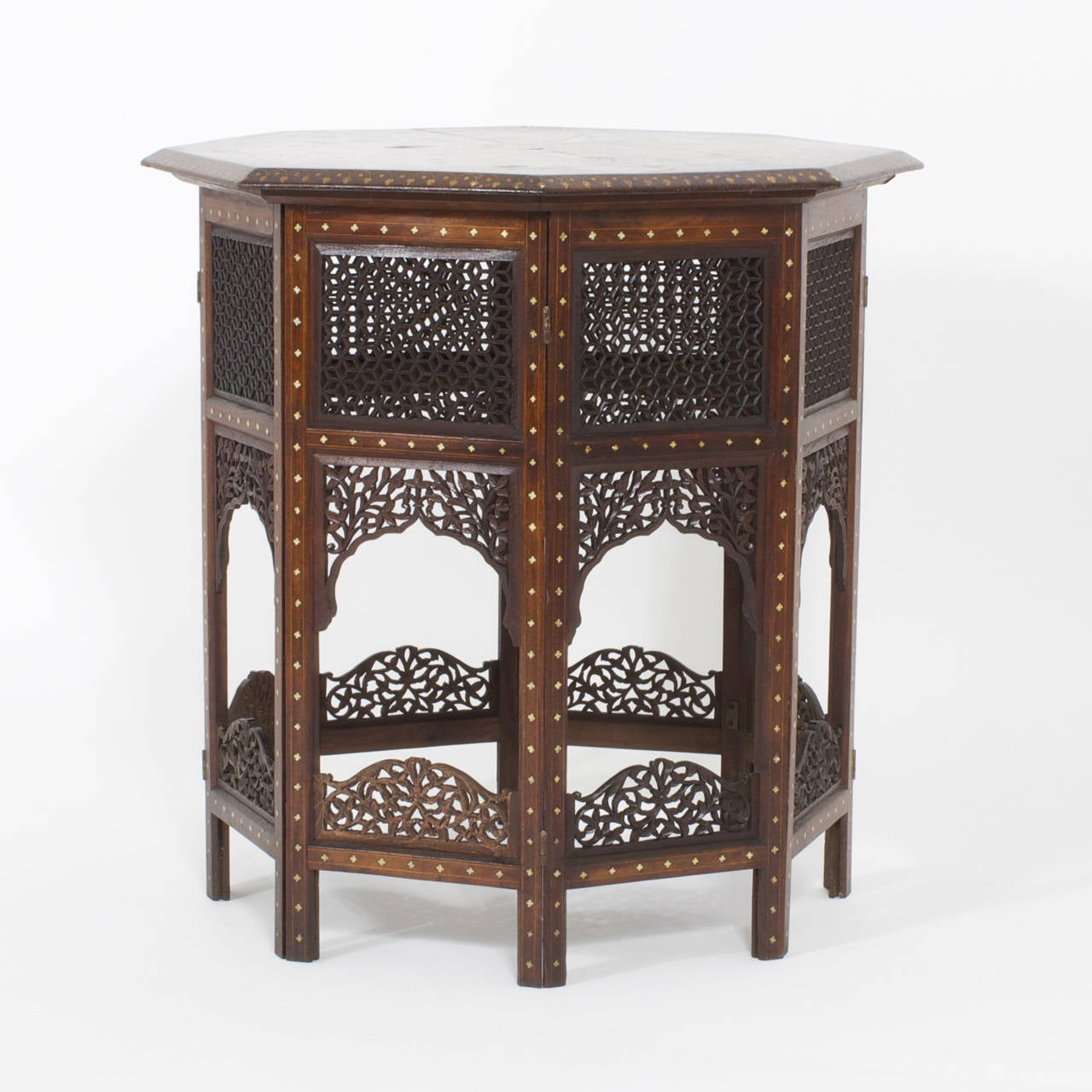 Anglo-Indian occasional folding table with octagonal top decorated with elaborate floral inlaid bone patterns, sitting snugly on an eight-sided base with extensive open fret work carving and bone inlay. This is one of the best of its type, that we