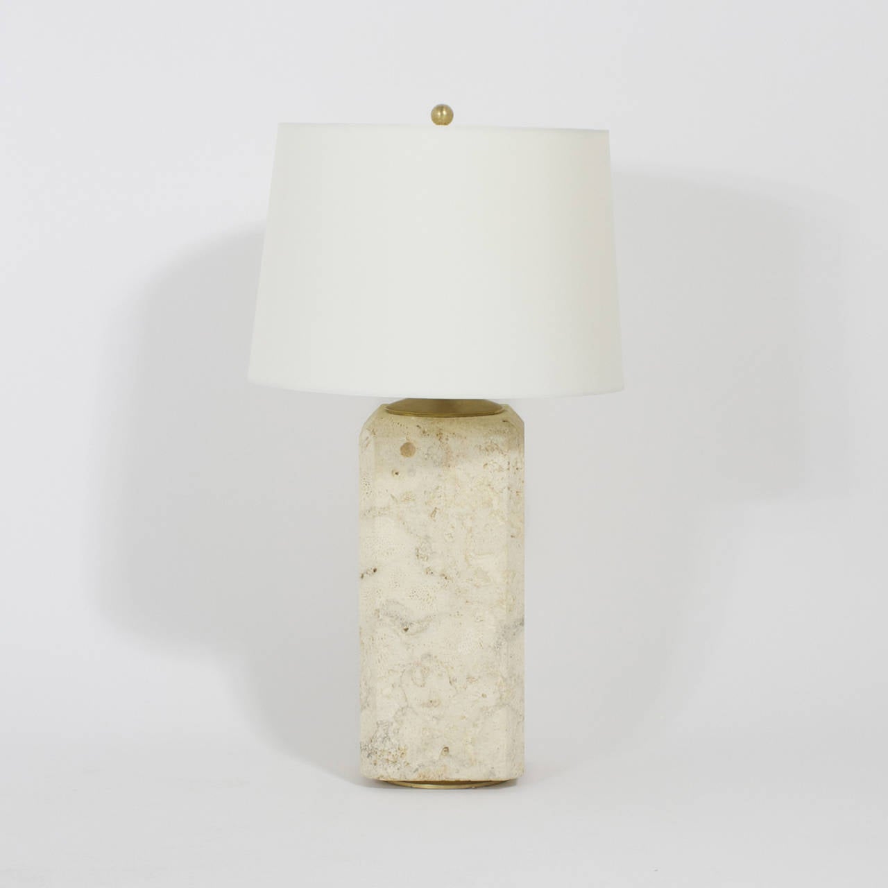 A handsome, mid century pair of coquina stone table lamps with beveled corners, and a chic sliver of a brass foot and over all decorated by Mother Nature. Newly wired.
A wonderful organic addition to your modern, beach, seaside or traditional decor.