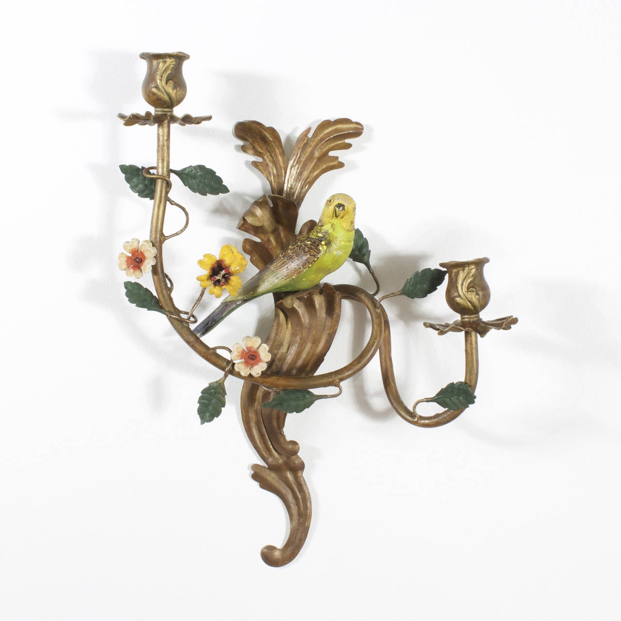 Amusing, opposing pair of Italian Tole sconces with rather happy yellow, green and brown parakeets set in a floral scene of gold painted acanthus leaves, and having 2 organic shaped arms decorated with colorful flowers and small green leaves.
