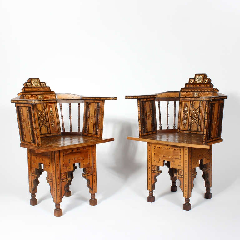 A pair of Syrian barrel back chairs with geometric lines and exotic wood inlays with other of pearl. Sometimes referred to as Moroccan. We are dating these as early 20th century, but they could be 19th century.

