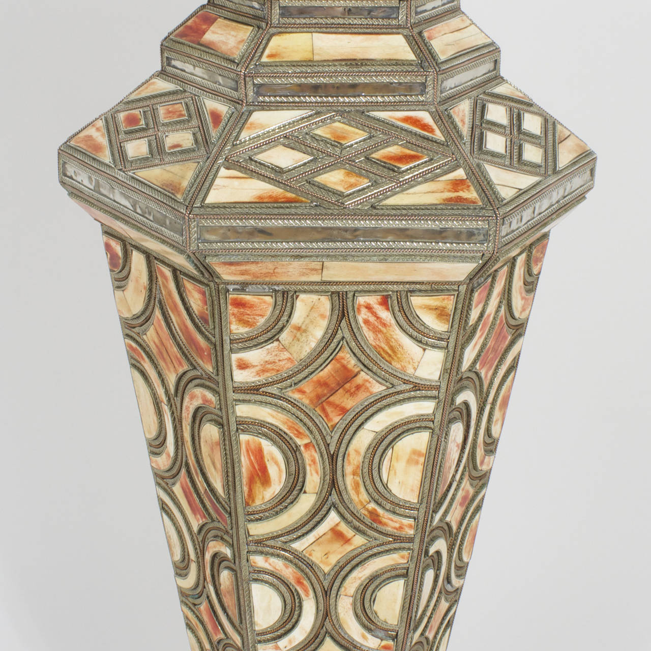 An exciting find that will elevate any interior design with eye-catching appeal! A large,  jardiniere with an exotic blend of materials and a strong geometric form.This vessel has a wide opening at the top and is decorated with hand hammered