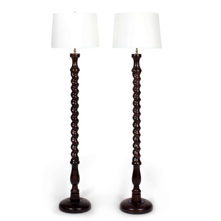 A pair of barley twist floor lamps, with a dark stained carved wood columns and turned wood bases. Great size and dramatic in a pair. Newly wired.
Shade is 14