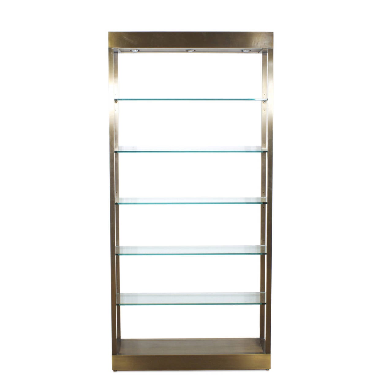 A handsome Midcentury polished, brushed brass with a lacquered finish and  thick, substantial glass shelves that are adjustable to height. There are three spotlights in the upper casing and a dimmer switch for lighting options. Display your