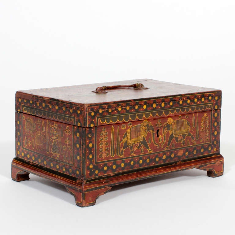 A very charming Anglo Indian painted decorated box with elephant, people, peacocks and mystical animal motifs, an outside bracket base and a brass handle. Great movement to the figures, all in three colors with black borders.

  