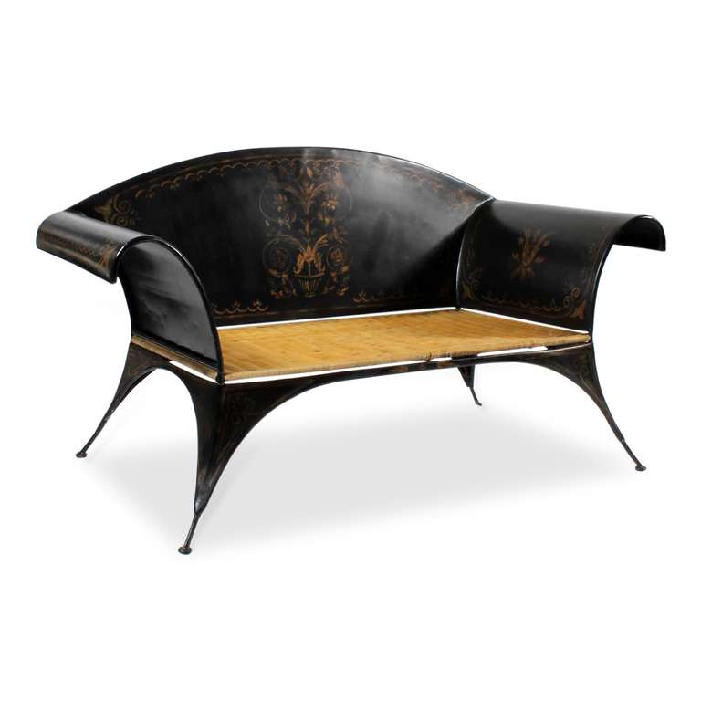 Talk about great form, this is it! A fabulous Chippendale style black tole settee with a woven seat, and worn gold hand-painted floral decoration. A very dramatic piece, in the best of form, super decorative.